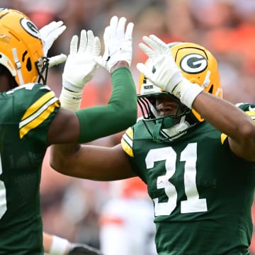 Green Bay Packers running back Emanuel Wilson (31) celebrates with wide receiver Malik Heath (18) after scoring a touchdown at the Cleveland Browns.