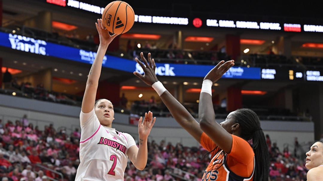 Feb 22, 2026; Louisville, Kentucky, USA;  Louisville Cardinals guard Imari Berry (2) ) shoots against Virginia Cavaliers forward Tabitha Amanze (7) during the first half at KFC Yum! Center. Mandatory Credit: Jamie Rhodes-Imagn Images