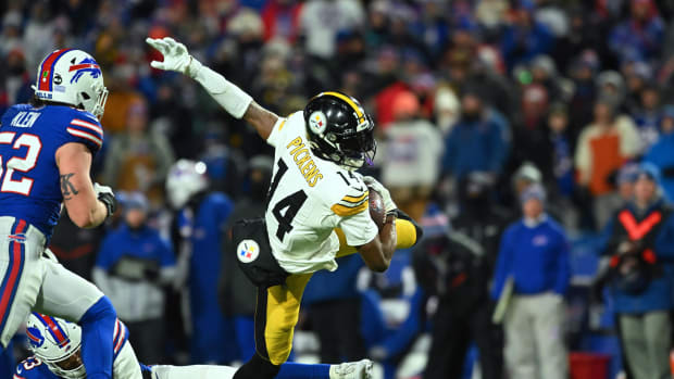 Pittsburgh Steelers wide receiver George Pickens (14) outs runs a tackle attempt by Buffalo Bills safety Micah Hyde 