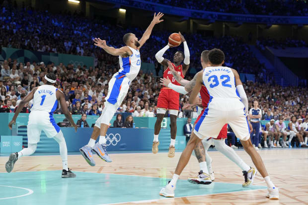 Germany point guard Dennis Schroder shoots against France center Rudy Gobert.