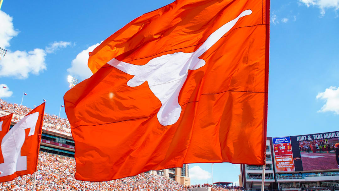 Aug 31, 2024; Austin, Texas, USA; Texas Longhorns cheerleaders waves the flag after a topdown during the first half of s gams at Darrell K Royal-Texas Memorial Stadium. Mandatory Credit: Aaron Meullion-Imagn Images