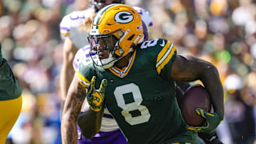 Sep 29, 2024; Green Bay, Wisconsin, USA;  Green Bay Packers running back Josh Jacobs (8) rushes with the football during the first quarter against the Minnesota Vikings at Lambeau Field.
