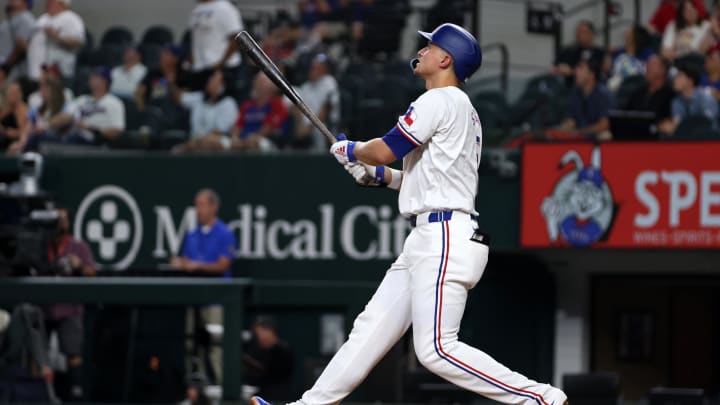 Aug 19, 2024; Arlington, Texas, USA; Texas Rangers shortstop Corey Seager (5) hits a three-run home run against the Pittsburgh Pirates in the third inning at Globe Life Field. Mandatory Credit: Tim Heitman-USA TODAY Sports