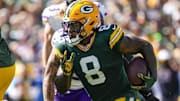 Sep 29, 2024; Green Bay, Wisconsin, USA;  Green Bay Packers running back Josh Jacobs (8) rushes with the football during the first quarter against the Minnesota Vikings at Lambeau Field.