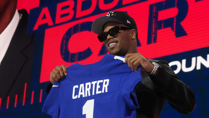 Penn State defensive end Abdul Carter poses with the New York Giants jersey after being selected by them at the 2025 NFL draft.