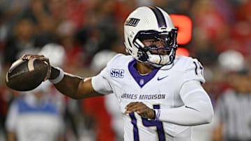 Sep 5, 2025; Louisville, Kentucky, USA;  James Madison Dukes quarterback Alonza Barnett III (14) looks to pass against the Louisville Cardinals during the first half at L&N Federal Credit Union Stadium. Louisville defeated James Madison 28-14. Mandatory Credit: Jamie Rhodes-Imagn Images