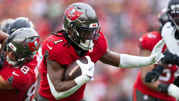 Dec 24, 2023; Tampa, Florida, USA; Tampa Bay Buccaneers running back Rachaad White (1) runs the ball against the Jacksonville Jaguars in the first quarter at Raymond James Stadium. Mandatory Credit: Jeremy Reper-USA TODAY Sports