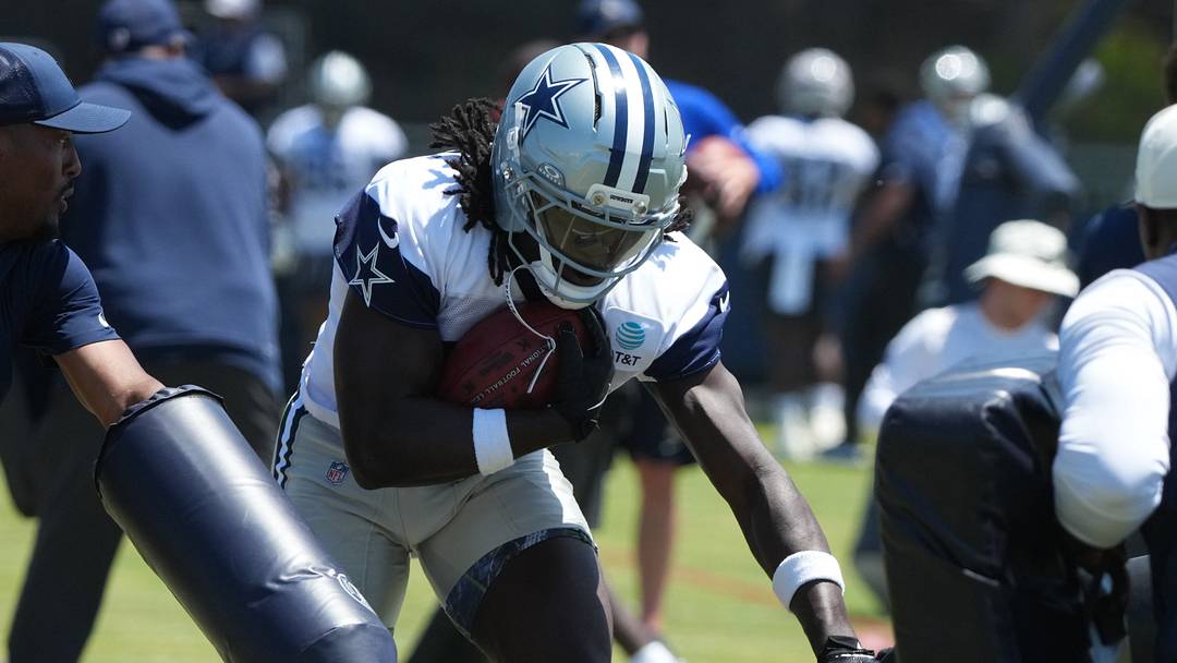 Dallas Cowboys running back Israel Abanikanda carries the ball at training camp at River Ridge Playing Fields. Dallas Cowboys running back Israel Abanikanda carries the ball at training camp at River Ridge Playing Fields.