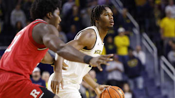 Dec 6, 2025; Ann Arbor, Michigan, USA;  Michigan Wolverines forward Morez Johnson Jr. (21) dribbles in the first half against the Rutgers Scarlet Knights at Crisler Center. Mandatory Credit: Rick Osentoski-Imagn Images