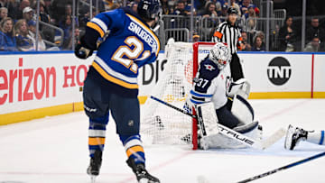 May 2, 2025; St. Louis, Missouri, USA; St. Louis Blues right wing Jimmy Snuggerud (21) is unable to score past Winnipeg Jets goaltender Connor Hellebuyck (37) during the second period in game six of the first round of the 2025 Stanley Cup Playoffs at Enterprise Center. Mandatory Credit: Connor Hamilton-Imagn Images