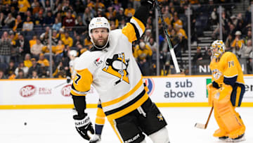 Dec 19, 2024; Nashville, Tennessee, USA;  Pittsburgh Penguins right wing Bryan Rust (17) celebrates the game winner against the Nashville Predators during the 1st overtime period at Bridgestone Arena. Mandatory Credit: Steve Roberts-Imagn Images