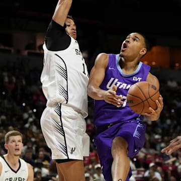 Jul 14, 2025; Las Vegas, NV, USA;  Utah Jazz forward John Tonje (17) drives towards the basket against San Antonio Spurs forward Carter Bryant (11) during the first half of a NBA basketball game at the Thomas & Mack Center. 
