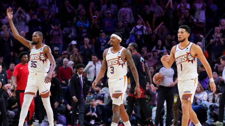 Jan 22, 2024; Phoenix, Arizona, USA; Phoenix Suns forward Kevin Durant (35) and Phoenix Suns guard Bradley Beal (3) and Phoenix Suns guard Devin Booker (1) reacts during the second half of the game against the Chicago Bulls at Footprint Center. Mandatory Credit: Joe Camporeale-USA TODAY Sports