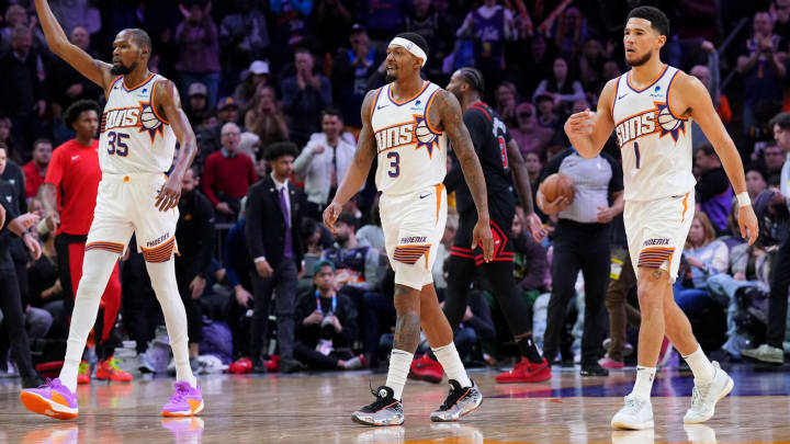 Jan 22, 2024; Phoenix, Arizona, USA; Phoenix Suns forward Kevin Durant (35) and Phoenix Suns guard Bradley Beal (3) and Phoenix Suns guard Devin Booker (1) reacts during the second half of the game against the Chicago Bulls at Footprint Center. Mandatory Credit: Joe Camporeale-USA TODAY Sports