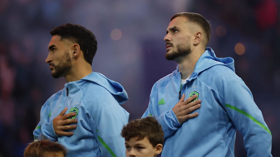 Seattle Sounders FC midfielder Cristian Roldan and forward Jordan Morris during the National Anthem before the match against the Houston Dynamo FC. | Joe Nicholson-Imagn Images