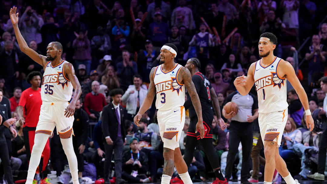Jan 22, 2024; Phoenix, Arizona, USA; Phoenix Suns forward Kevin Durant (35) and Phoenix Suns guard Bradley Beal (3) and Phoenix Suns guard Devin Booker (1) reacts during the second half of the game against the Chicago Bulls at Footprint Center. Mandatory Credit: Joe Camporeale-Imagn Images