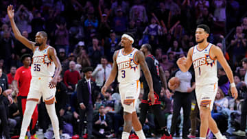 Jan 22, 2024; Phoenix, Arizona, USA; Phoenix Suns forward Kevin Durant (35) and Phoenix Suns guard Bradley Beal (3) and Phoenix Suns guard Devin Booker (1) reacts during the second half of the game against the Chicago Bulls at Footprint Center. Mandatory Credit: Joe Camporeale-Imagn Images