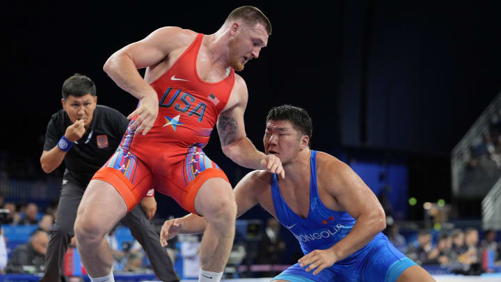 Aug 9, 2024; Paris, France; Lkhagvagerel Munktur (MGL) defeats Mason Mark Parris (USA) in a menís freestyle 125kg 1/8 final during the Paris 2024 Olympic Summer Games at Champ-de-Mars Arena. Mandatory Credit: John David Mercer-USA TODAY Sports