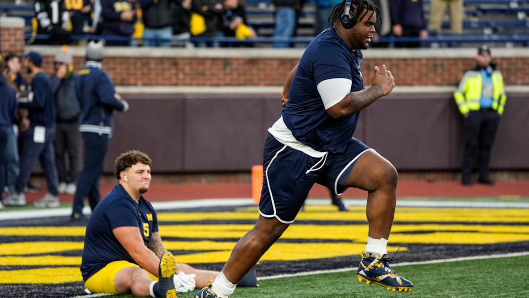 Michigan defensive lineman Kenneth Grant (78), right, warm up next to defensive lineman Mason Graham (55) before the Michigan State game at Michigan Stadium in Ann Arbor on Saturday, Oct. 26, 2024.