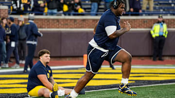 Michigan defensive lineman Kenneth Grant (78), right, warm up next to defensive lineman Mason Graham (55) before the Michigan State game at Michigan Stadium in Ann Arbor on Saturday, Oct. 26, 2024.