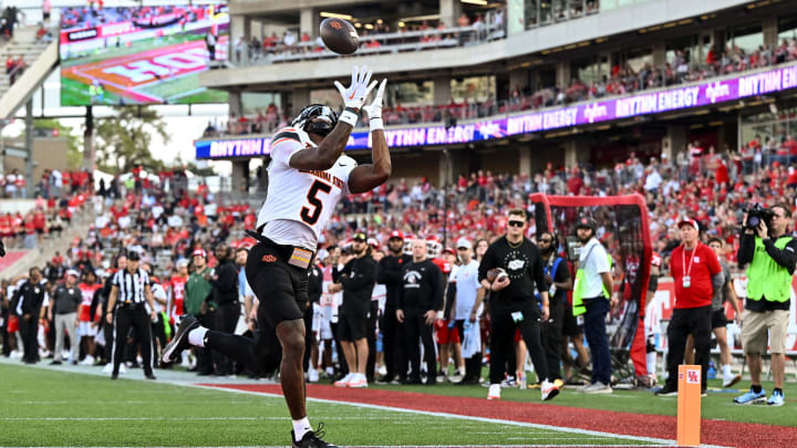 Nov 18, 2023; Houston, Texas, USA; Oklahoma State Cowboys wide receiver Jaden Bray (5) catches a pass for a touchdown during the second quarter against the Houston Cougars at TDECU Stadium. Mandatory Credit: Maria Lysaker-USA TODAY Sports