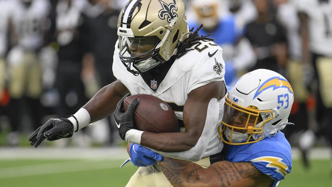 Aug 20, 2023; Inglewood, California, USA; Los Angeles Chargers linebacker Blake Lynch (53) tackles New Orleans Saints running back Kendre Miller (25) after a short pass play in the first quarter at SoFi Stadium. Mandatory Credit: Robert Hanashiro-Imagn Images