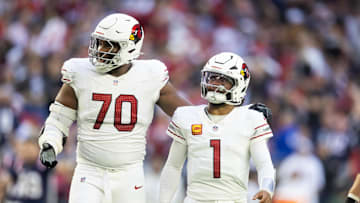Dec 15, 2024; Glendale, Arizona, USA; Arizona Cardinals offensive tackle Paris Johnson Jr. (70) and quarterback Kyler Murray (1) against the New England Patriots at State Farm Stadium. Mandatory Credit: Mark J. Rebilas-Imagn Images