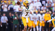 Aug 29, 2024; Boulder, Colorado, USA; North Dakota State Bison quarterback Cam Miller (7) scrambles in the second quarter against the Colorado Buffaloes at Folsom Field. Mandatory Credit: Ron Chenoy-Imagn Images
