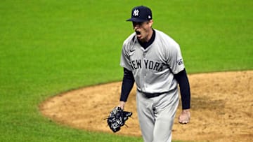 Oct 19, 2024; Cleveland, Ohio, USA; New York Yankees pitcher Tim Hill (54) celebrates after an inning end double play during the sixth inning against the Cleveland Guardians during game five of the ALCS for the 2024 MLB playoffs at Progressive Field. Mandatory Credit: David Richard-Imagn Images