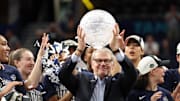 Apr 6, 2025; Tampa, FL, USA; Connecticut Huskies head coach Geno Auriemma holds up the WBCA Coaches’ trophy after the national championship of the women's 2025 NCAA tournament against the South Carolina Gamecocks at Amalie Arena. Mandatory Credit: Nathan Ray Seebeck-Imagn Images