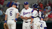 Sep 20, 2025; Arlington, Texas, USA; Texas Rangers manager Bruce Bochy (15) stands on the mound with third baseman Josh Jung (6) and catcher Kyle Higashioka (11) as he makes a pitching change during the seventh inning against the Miami Marlins at Globe Life Field. 