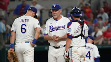 Sep 20, 2025; Arlington, Texas, USA; Texas Rangers manager Bruce Bochy (15) stands on the mound with third baseman Josh Jung (6) and catcher Kyle Higashioka (11) as he makes a pitching change during the seventh inning against the Miami Marlins at Globe Life Field. 