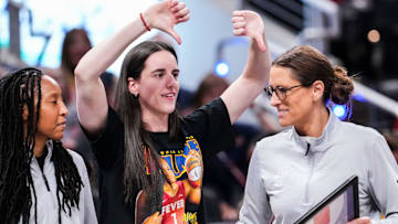 Indiana Fever guard Caitlin Clark (22) jokes with Indiana Fever head coach Stephanie White on Saturday, Aug. 9, 2025, during a game between the Indiana Fever and the Chicago Sky at Gainbridge Fieldhouse in Indianapolis.