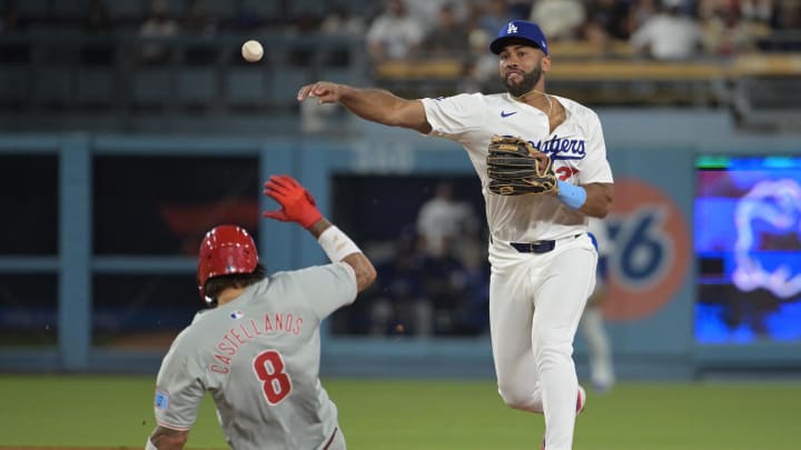 Aug 6, 2024; Los Angeles, California, USA;  Philadelphia Phillies right fielder Nick Castellanos (9) is out at second as Los Angeles Dodgers right fielder Amed Rosario (27) throws to first for a double play in the eighth inning at Dodger Stadium.