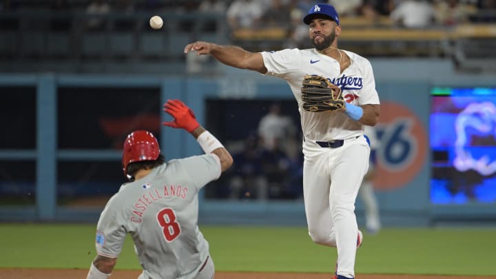 Aug 6, 2024; Los Angeles, California, USA;  Philadelphia Phillies right fielder Nick Castellanos (9) is out at second as Los Angeles Dodgers right fielder Amed Rosario (27) throws to first for a double play in the eighth inning at Dodger Stadium. Mandatory Credit: Jayne Kamin-Oncea-USA TODAY Sports