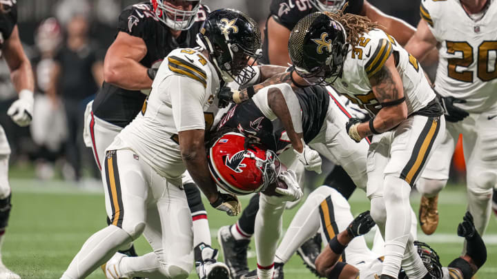 Nov 26, 2023; Atlanta, Georgia, USA; Atlanta Falcons running back Cordarrelle Patterson (84) is tackled by New Orleans Saints defensive end Cameron Jordan (94) and safety Tyrann Mathieu (32) during the first half at Mercedes-Benz Stadium. Mandatory Credit: Dale Zanine-USA TODAY Sports