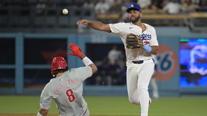 Aug 6, 2024; Los Angeles, California, USA;  Philadelphia Phillies right fielder Nick Castellanos (9) is out at second as Los Angeles Dodgers right fielder Amed Rosario (27) throws to first for a double play in the eighth inning at Dodger Stadium. Mandatory Credit: Jayne Kamin-Oncea-USA TODAY Sports