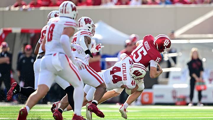 Nov 15, 2025; Bloomington, Indiana, USA; Indiana Hoosiers quarterback Fernando Mendoza (15) is sacked by Wisconsin Badgers linebacker Cooper Catalano (44) during the second half at Memorial Stadium. Mandatory Credit: Marc Lebryk-Imagn Images