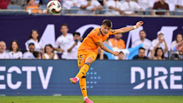 Jul 31, 2024; Chicago, IL, USA; Real Madrid midfielder Arda Guler (15) shoots the ball against AC Milan during the first half at Soldier Field. Mandatory Credit: Daniel Bartel-Imagn Images