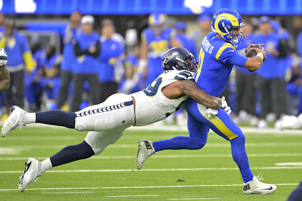 Los Angeles Rams quarterback Jimmy Garoppolo (11) is sacked by Seattle Seahawks defensive end Leonard Williams (99).
