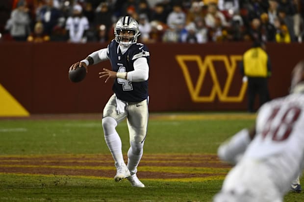 Dallas Cowboys quarterback Dak Prescott looks to pass against the Washington Commanders during the second half at FedExField.