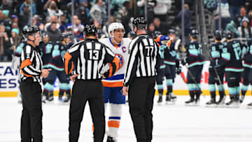 Nov 16, 2024; Seattle, Washington, USA; New York Islanders left wing Anders Lee (27) talks to linesman Caleb Apperson (77) after the game against the Seattle Kraken at Climate Pledge Arena. Mandatory Credit: Steven Bisig-Imagn Images