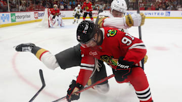 Mar 28, 2025; Chicago, Illinois, USA; Chicago Blackhawks center Frank Nazar (91) and Vegas Golden Knights center Jack Eichel (9) battle for control of the puck during the second period at United Center. Mandatory Credit: Talia Sprague-Imagn Images