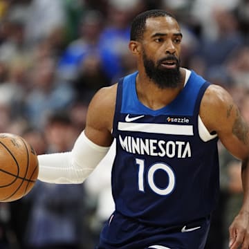 Mar 12, 2025; Denver, Colorado, USA; Minnesota Timberwolves guard Mike Conley (10) controls the ball in the first quarter against the Denver Nuggets at Ball Arena.