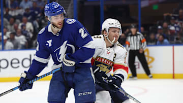 Apr 30, 2025; Tampa, Florida, USA; Florida Panthers left wing Matthew Tkachuk (19) and Tampa Bay Lightning center Brayden Point (21) skate  during the second period of game five of the first round of the 2025 Stanley Cup Playoffs at Amalie Arena. Mandatory Credit: Kim Klement Neitzel-Imagn Images