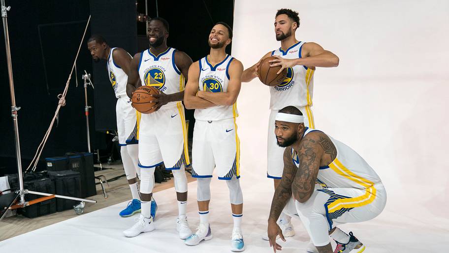 Golden State Warriors starters Kevin Durant, Draymond Green, Stephen Curry, Klay Thompson and DeMarcus Cousins pose.