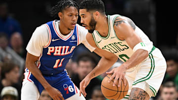 Boston Celtics forward Jayson Tatum (0) drives to the basket against Philadelphia 76ers guard Jeff Dowtin Jr.