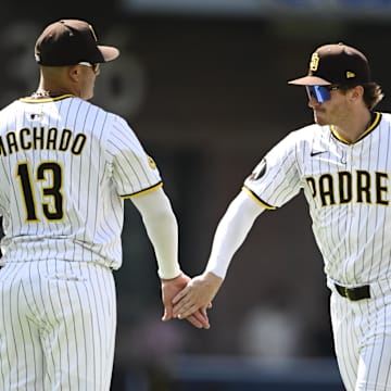 Jun 25, 2025; San Diego, California, USA; San Diego Padres center fielder Tyler Wade (14), right, and Manny Machado (13) celebrate after the Padres beat the Washington Nationals 1-0 at Petco Park. Mandatory Credit: Denis Poroy-Imagn Images