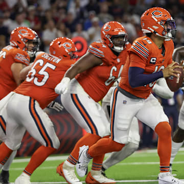 Caleb Williams tries to scramble away from Mario Edwards Jr. in the Bears' 19-13 loss to the Texans.