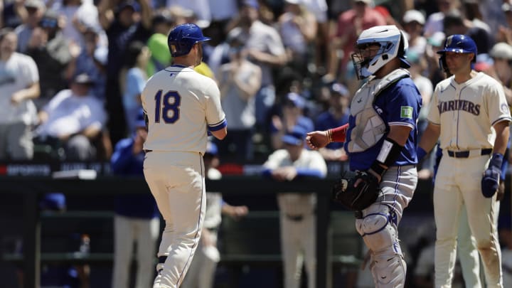 Seattle Mariners designated hitter Mitch Garver (18) crosses home on his three run home run against the Toronto Blue Jays during the fifth inning at T-Mobile Park on July 10.